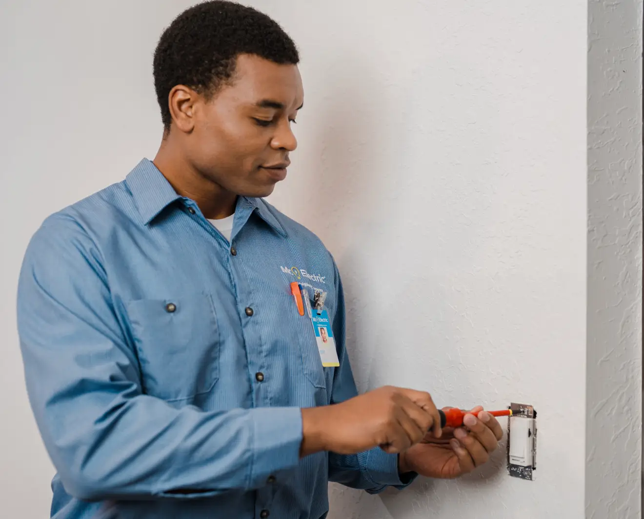 electrician repairing wall light switch
