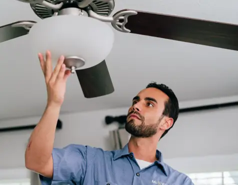 electrician repairing ceiling fan light