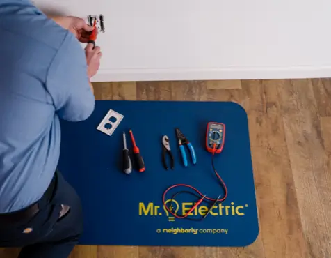 Home electrical repair service with electrician and tools for outlet repair