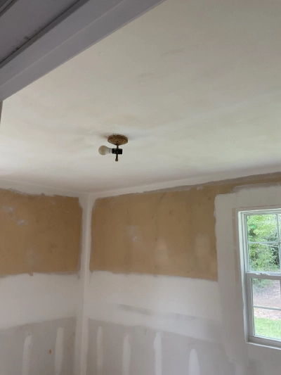 A room with a old damaged light fixture