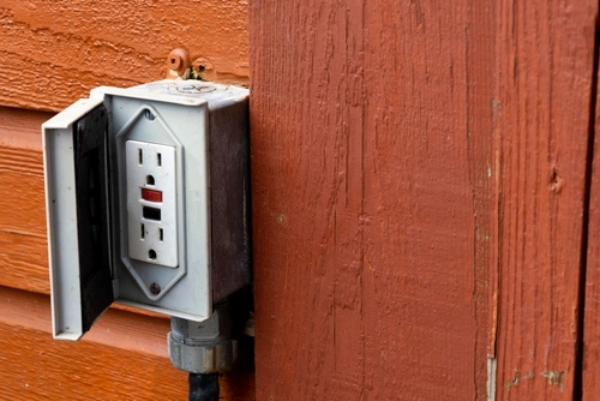 Outdoor GFCI outlet mounted to wood siding