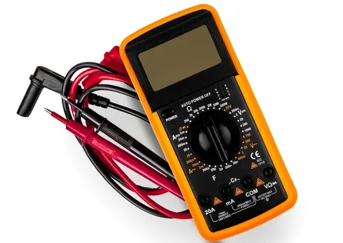 A digital multimeter with red and black leads and all dial settings visible