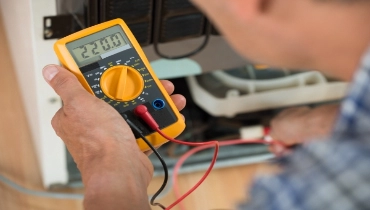 A professional electrician demonstrates how to use a multimeter