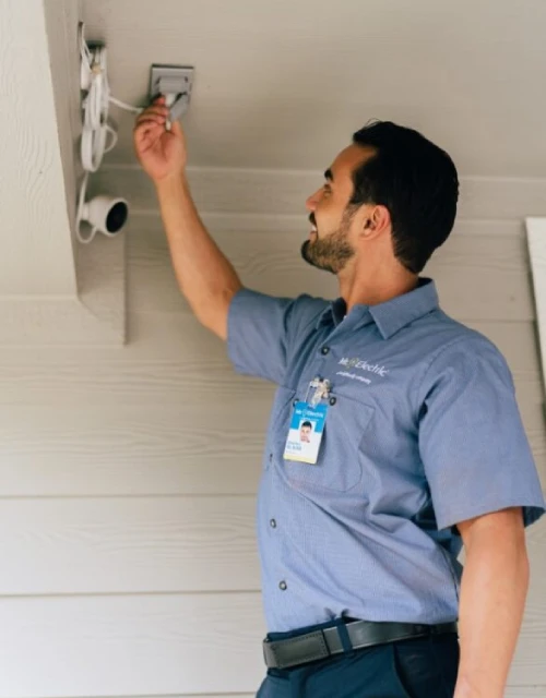 Mr. Electric electrician installing motion sensors