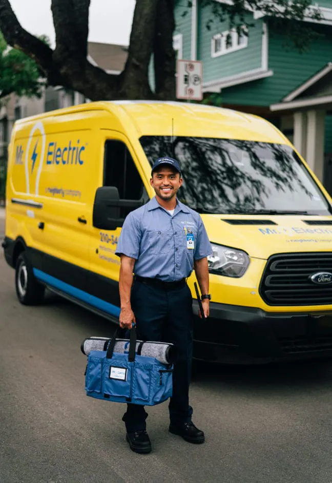 Smiling MRE technician in front of van.