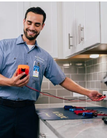 Mr. Electric electrician testing electricity outlet