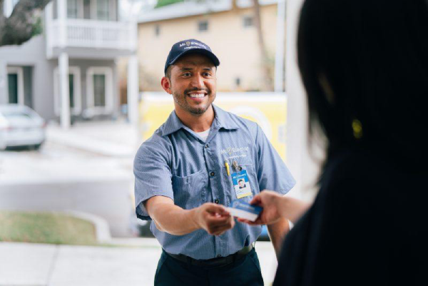 Mr electric electrician handing his business card to a customer.