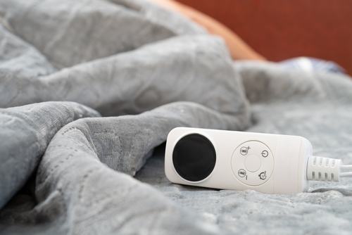 Close-up on electric blanket and controller.