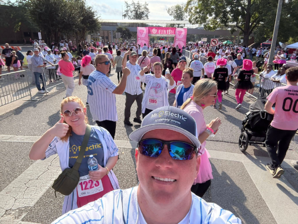 A person taking a selfie with a crowd of people