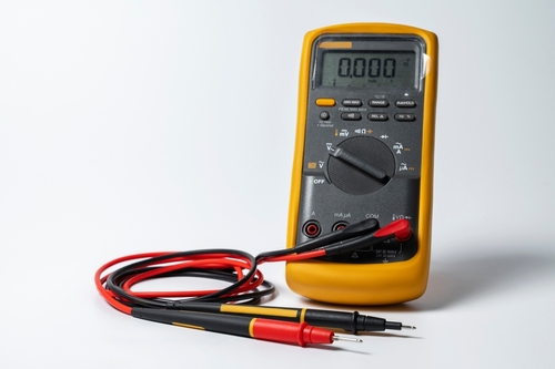 Yellow multimeter with probes.